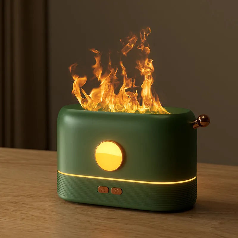 Black USB desktop humidifier with decorative orange flame effect and water tank on a wooden desk.