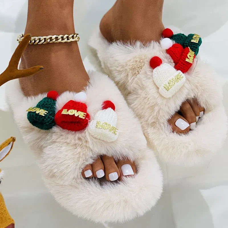 Women's Christmas slippers with a red hat decoration on a faux plush upper, shown in black.