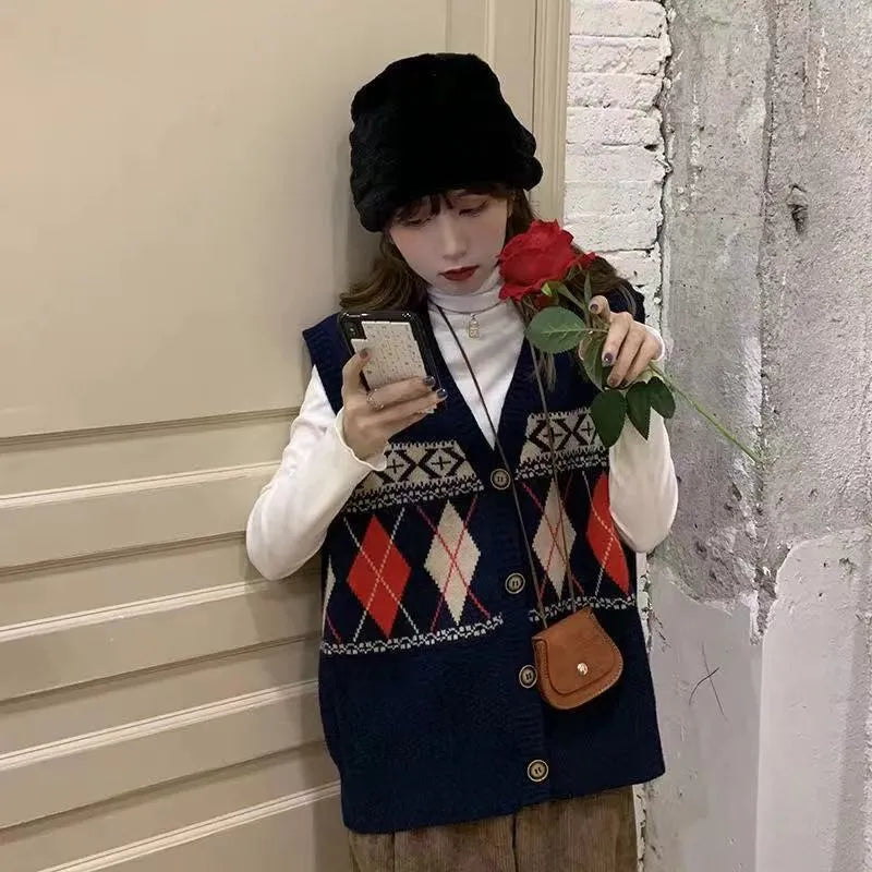 Khaki diamond plaid sleeveless cardigan top laid flat, showing loose fit and sleeveless armholes.