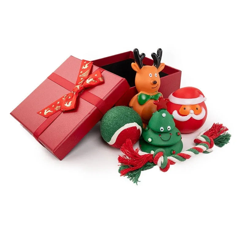 Christmas-themed vinyl dog toys including barbell, ball, rope, and Santa designs in gift packaging