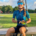Attaquer women's kaleidoscope pattern cycling jersey and pants set on a model.
