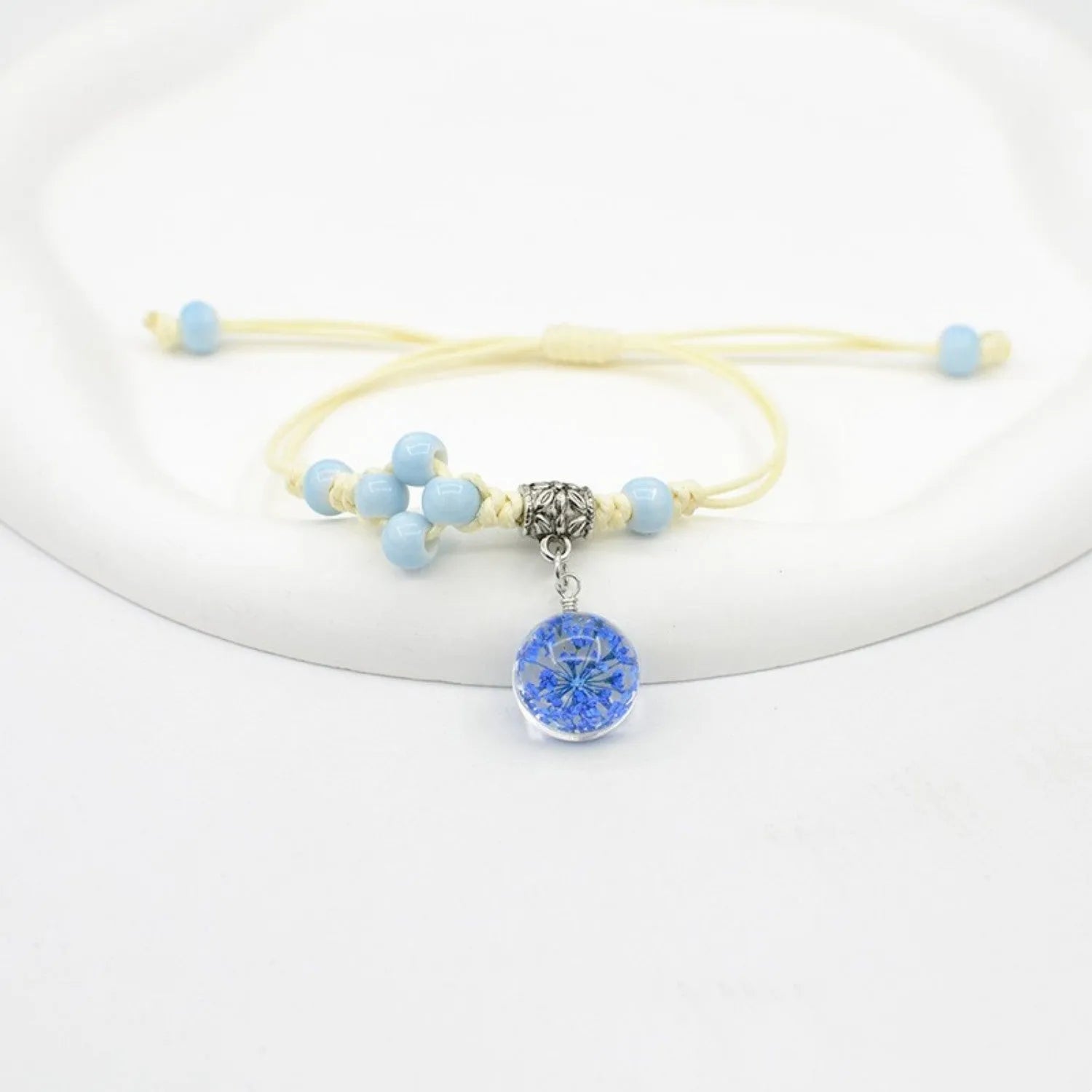 Hand-woven glass bracelet with 1.4cm beads containing real dried flowers in various colours