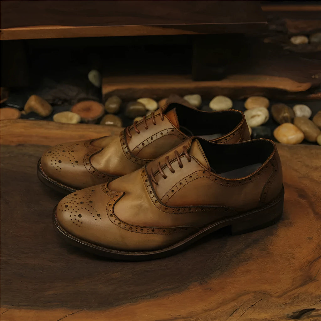 Light brown vintage engraved men's lace-up leather shoes with distressed finish and round toe.
