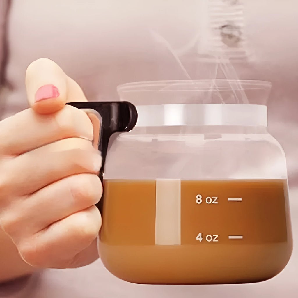 Transparent borosilicate glass stovetop coffee maker with a black silicone cover