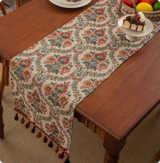 Country European retro style table flag with long handwoven tassels draped over a wooden sideboard.