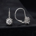 Sterling silver flower bud clip-on earrings with white gold plating and a central moissanite stone.