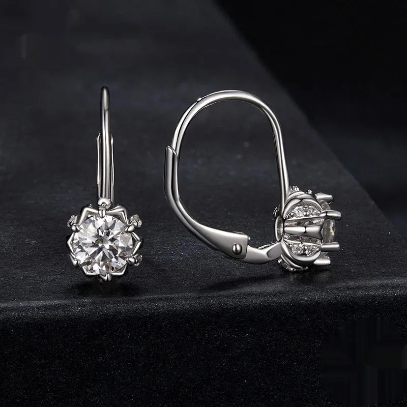 Sterling silver flower bud clip-on earrings with white gold plating and a central moissanite stone.