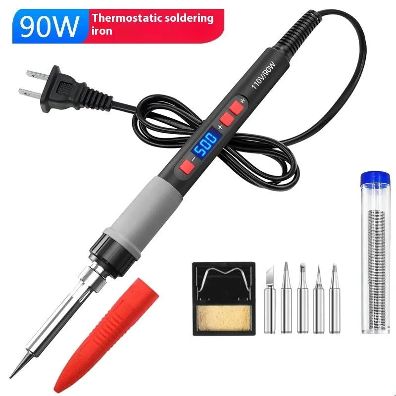Grey aluminium alloy 90W electric soldering iron kit with five tips, sponge, and solder on a workbench.
