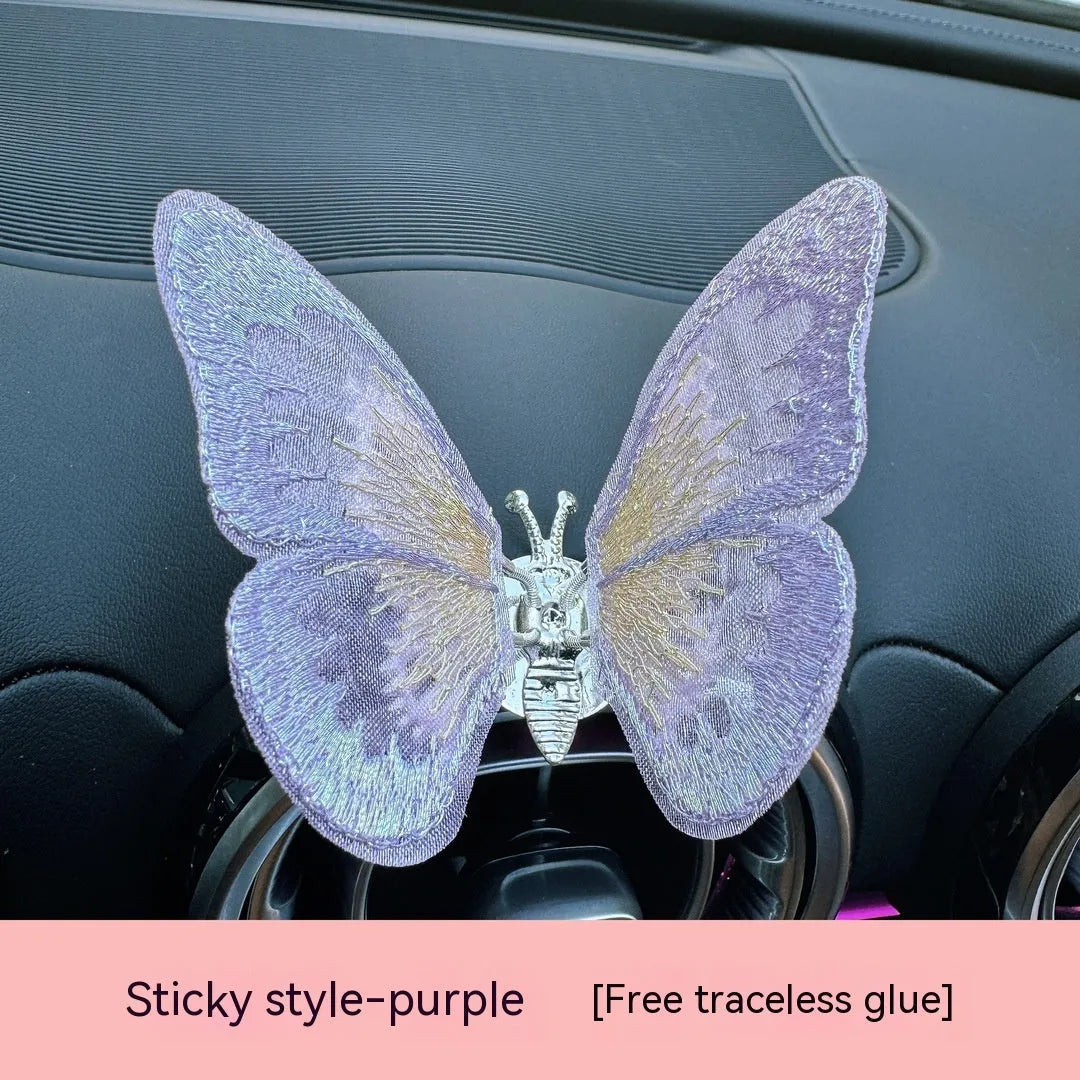 Moving embroidery butterfly decoration on car centre console air vent in pink fabric