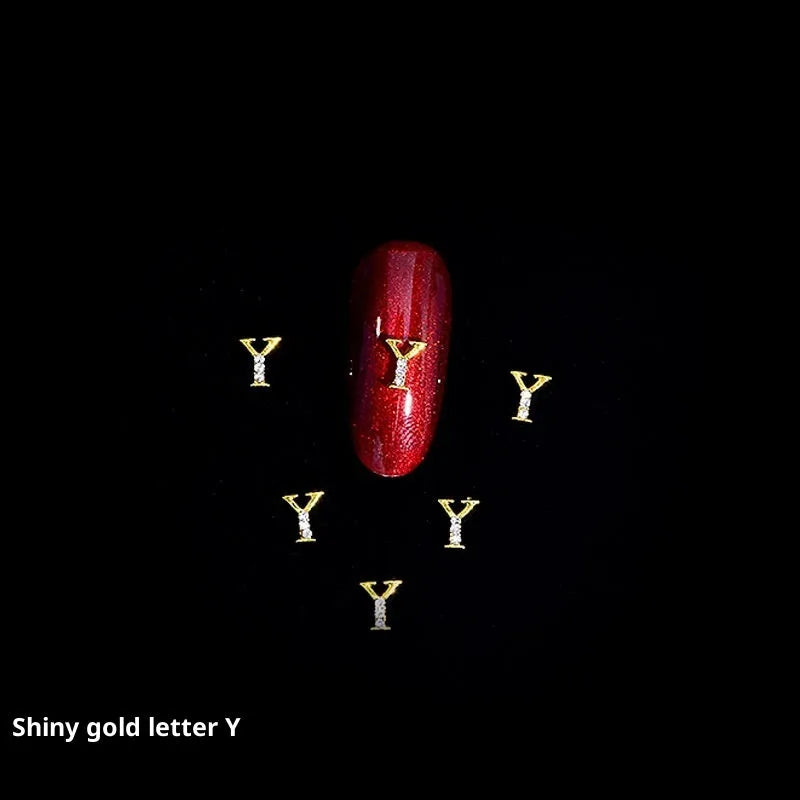 Gold alloy letter A nail ornament charm with crystal detail on a square chain base