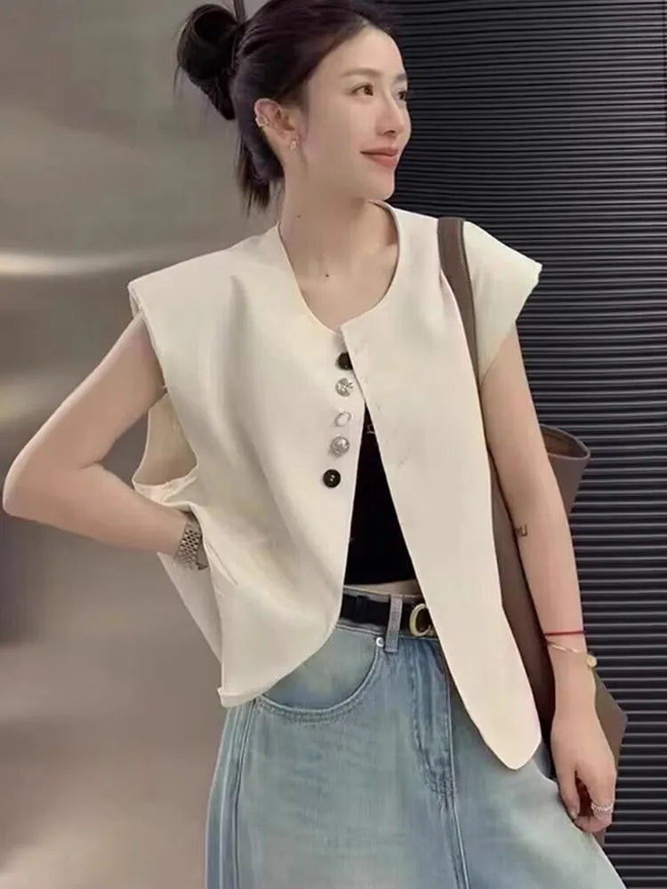 Women's loose fit polyester vest in milky white, featuring a short length and a front pocket.