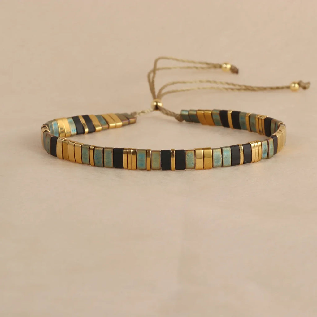 Geometric pull bead bracelet in milky white glass beads on a wrist.