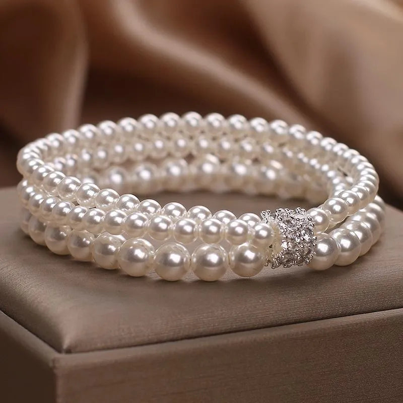 Baroque pearl multi-layer twin bracelet in white with electroplated finish on neutral background