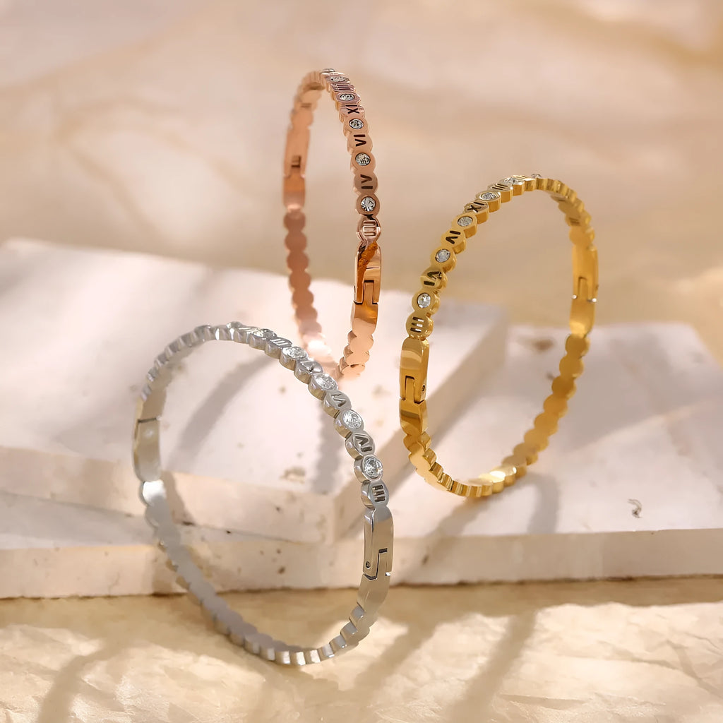 Titanium steel bracelet with number design in gold, rose gold, and steel colour options.