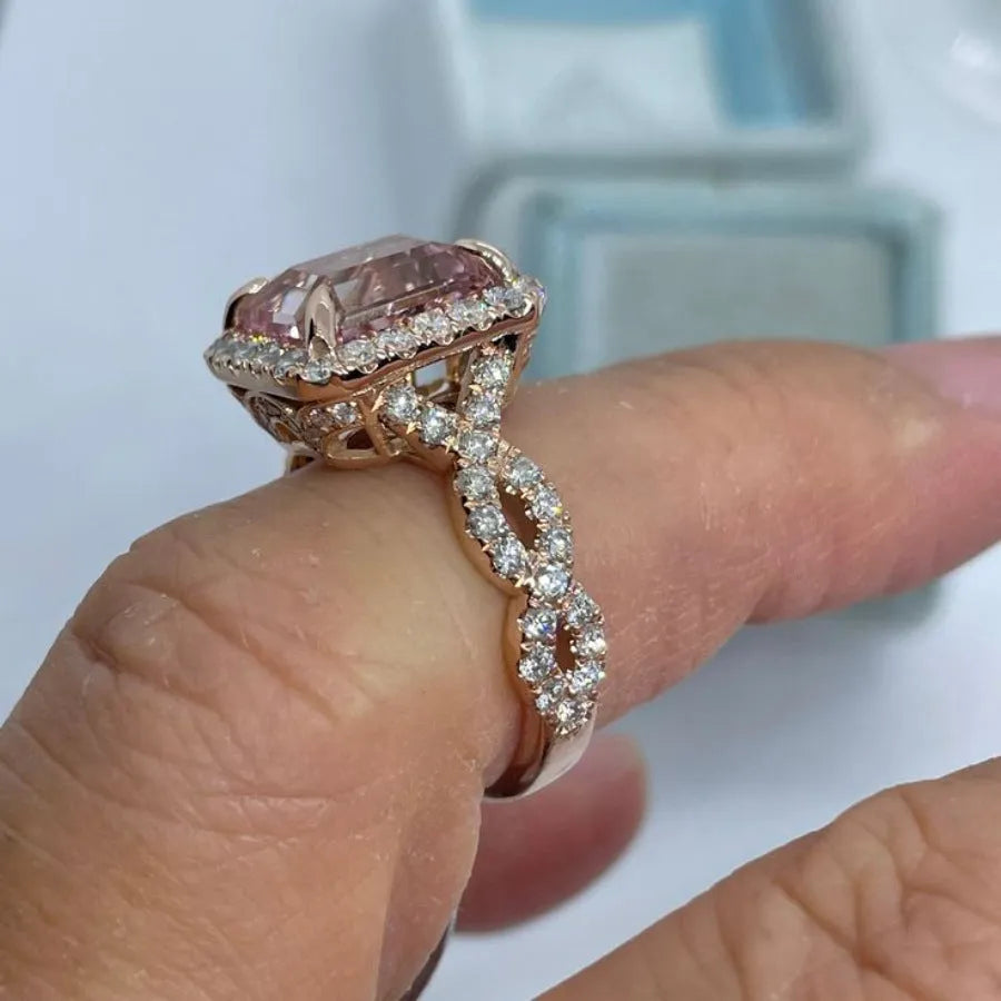 Rose gold geometric alloy ring on a plain background