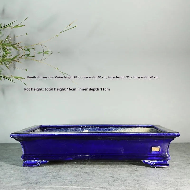 White cracked ceramic bonsai flowerpot with bamboo plant, manual purple sand craft