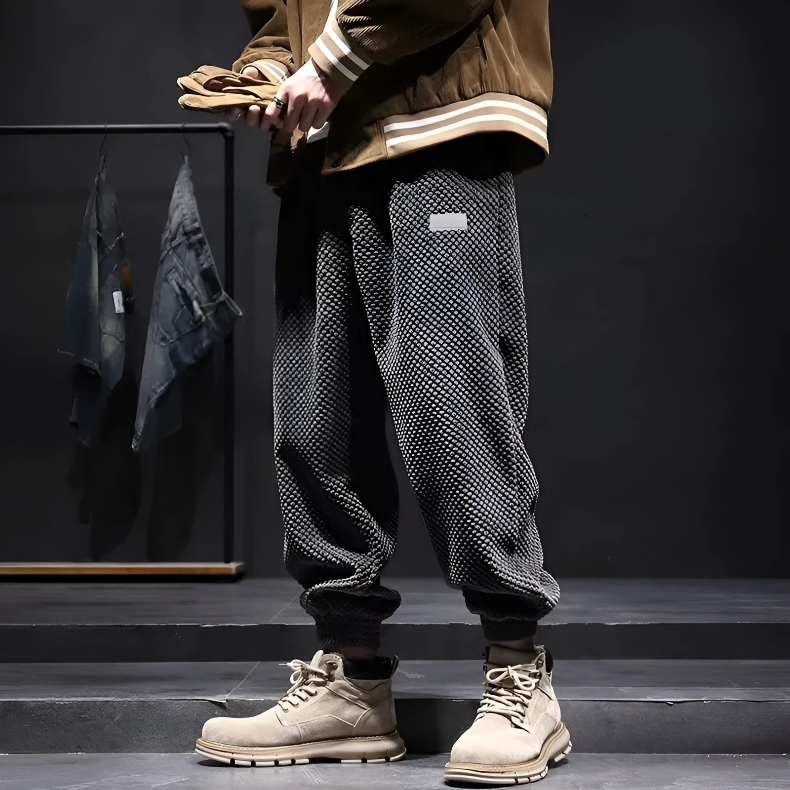 Men's grey ankle-tied straight leg sweatpants laid flat on a surface.