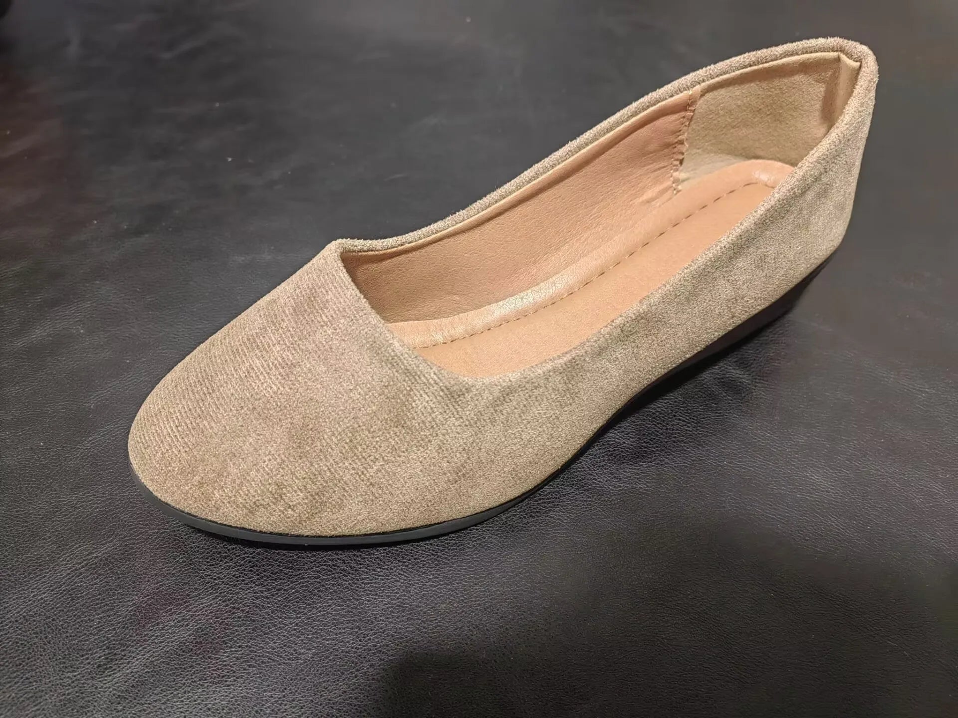 Women's suede wedge pump shoes in light brown with a low rubber sole and rounded toe.