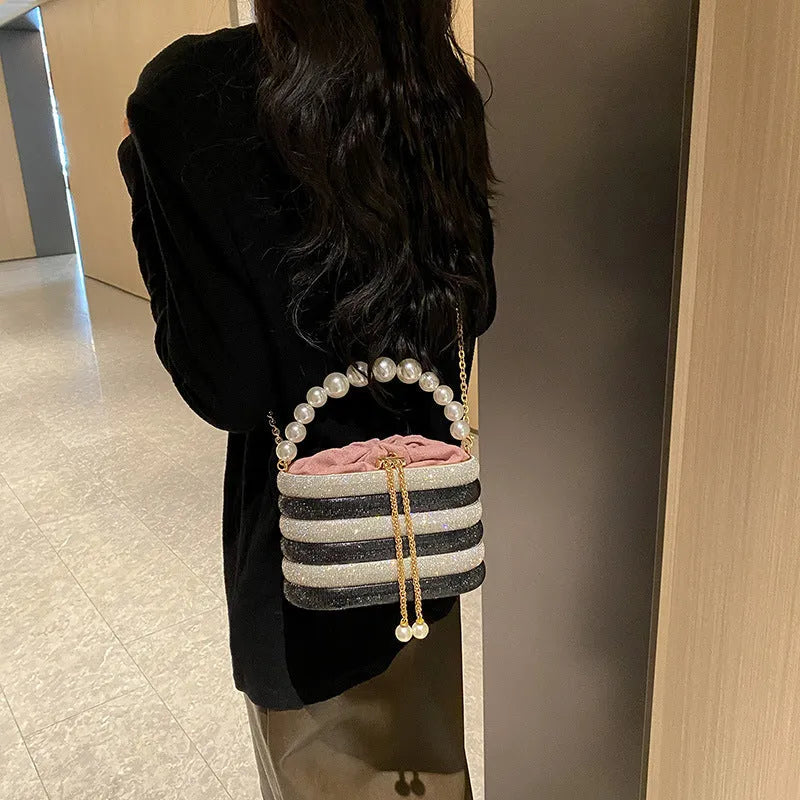 Retro style women's crossbody handbag with pearl beads in soft PU leather, shown in round shape.