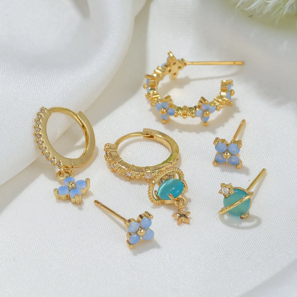 Flower-shaped stud earrings with zircon crystal centres in gold and silver colour options