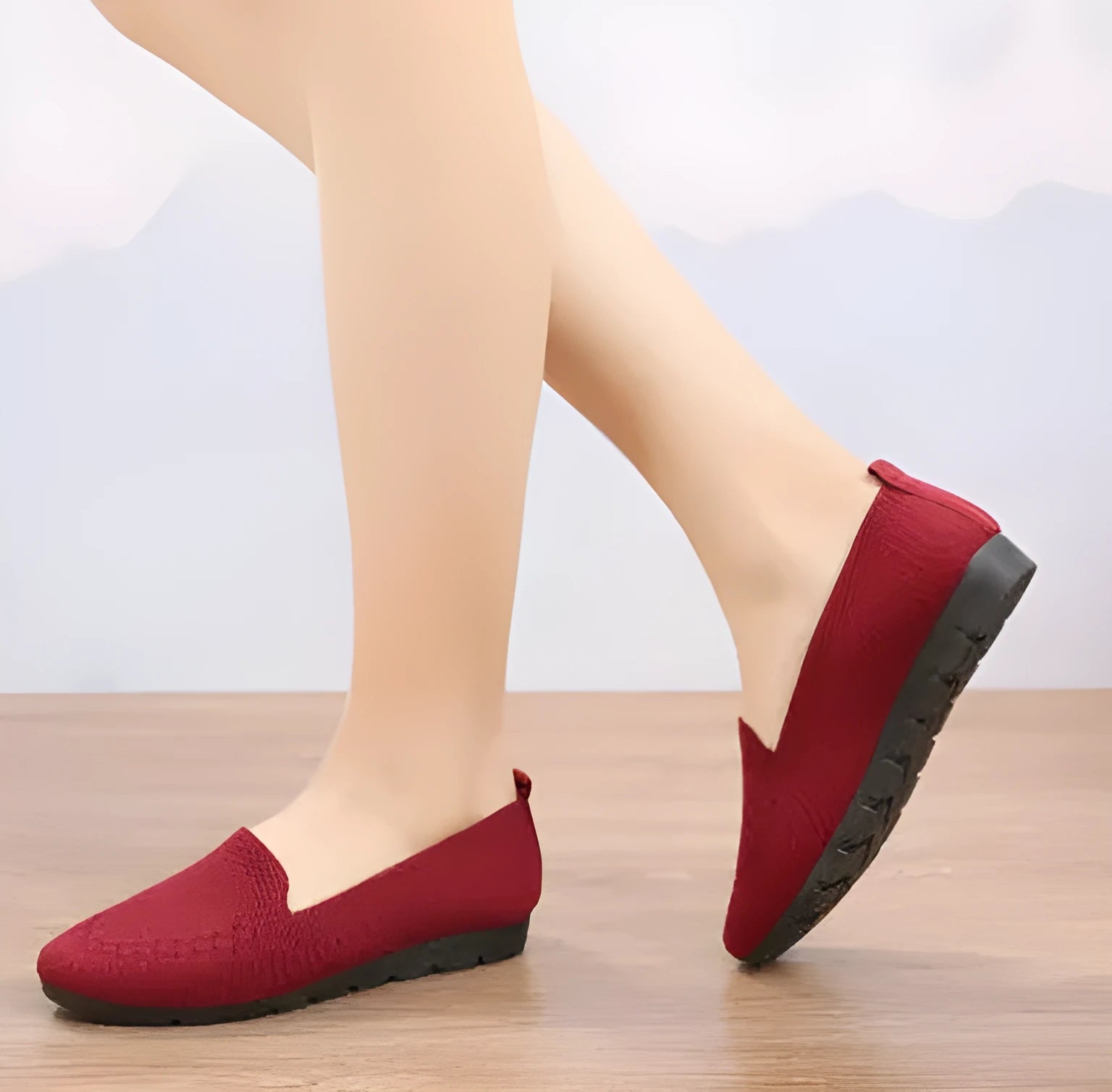 Women's casual flat shoes in black with breathable slip-on design
