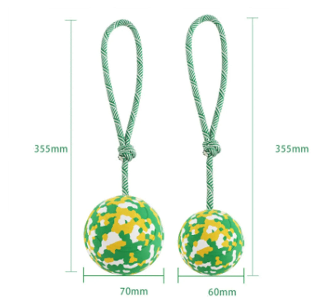 Natural rubber dog ball attached to a nylon rope for fetch and tug play.