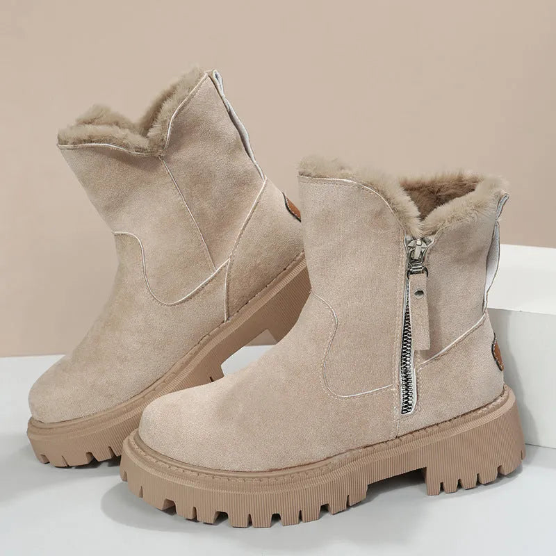 Women's black snow boots with foldable plush tube, suede upper, and rubber sole on winter pavement
