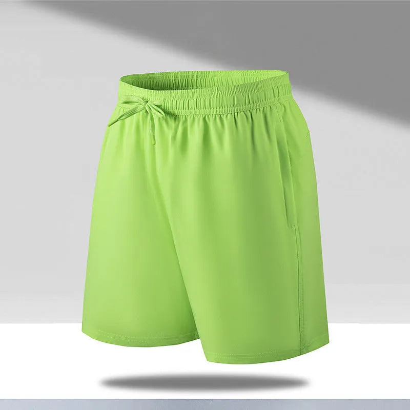 Man wearing loose-fit black quick-drying polyester beach shorts with a micro-elastic waistband.
