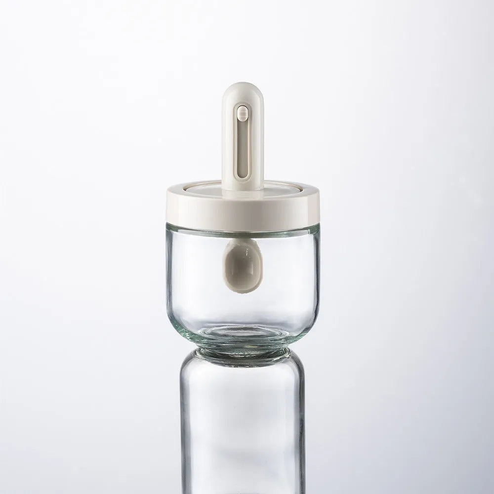 Glass telescopic spice seasoning bottle with leak-proof lid in transparent grey short style on kitchen counter