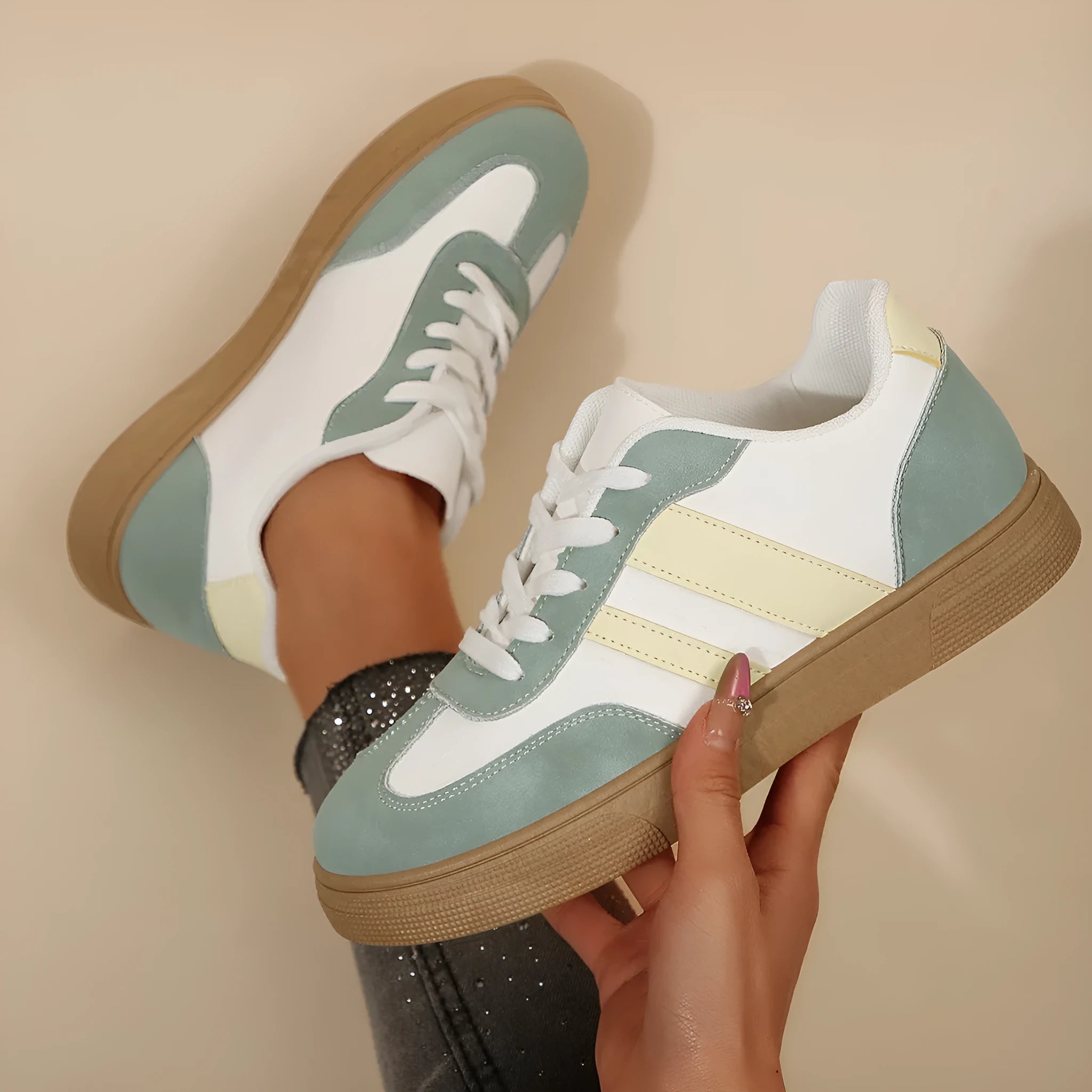 Green women's retro sports low-top shoes with cross straps and round toe on a rubber sole.