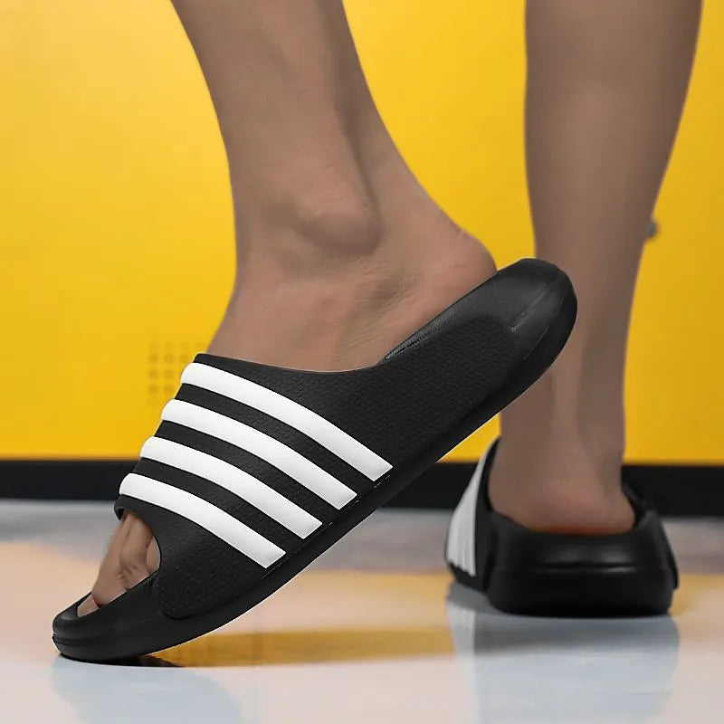 A pair of casual unisex slippers with an EVA sole and PVC upper, shown in a two-tone colour option.