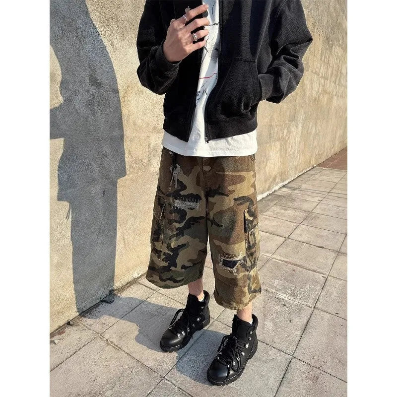 Men's camouflage cropped jeans with distressed patch detailing and straight-leg styling