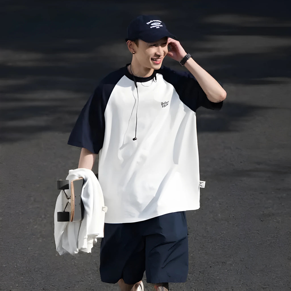 Blue loose-fit men's raglan sleeve T-shirt on a hanger, front view.