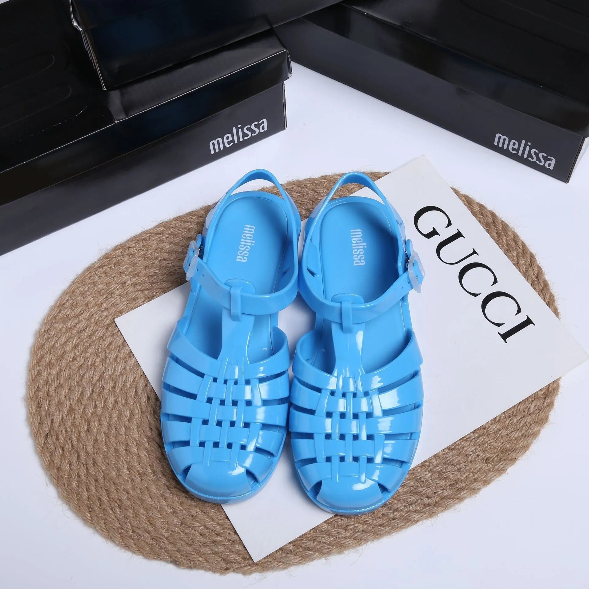 Black Roman-style sandals with buckle fastening and hollow-out design on low-top PVC upper