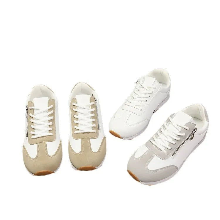 Women's grey flat-heeled shoes with artificial PU upper and rubber sole on a plain background.