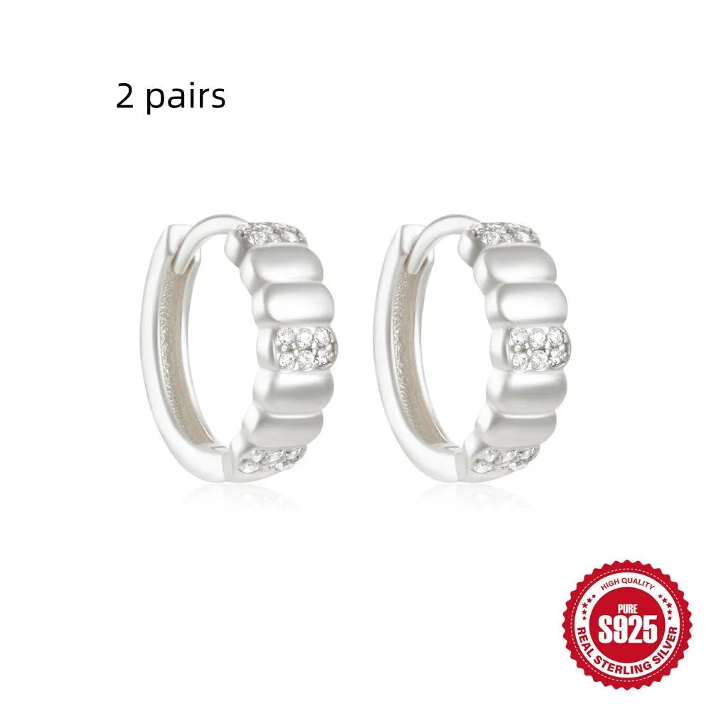 Small round geometric sterling silver stud earrings in gold and silver electroplated finishes.