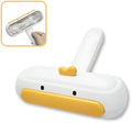 White portable pet hair remover roller with a yellow cartoon duck design on a table.