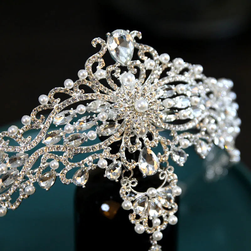 Silver alloy baroque bride crown with pearl and quota decoration on a white background
