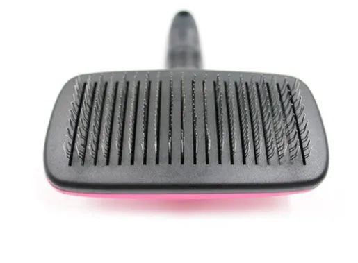 Automatic dehairing comb with stainless steel teeth and rose red handle, for dog and cat grooming, on a white background