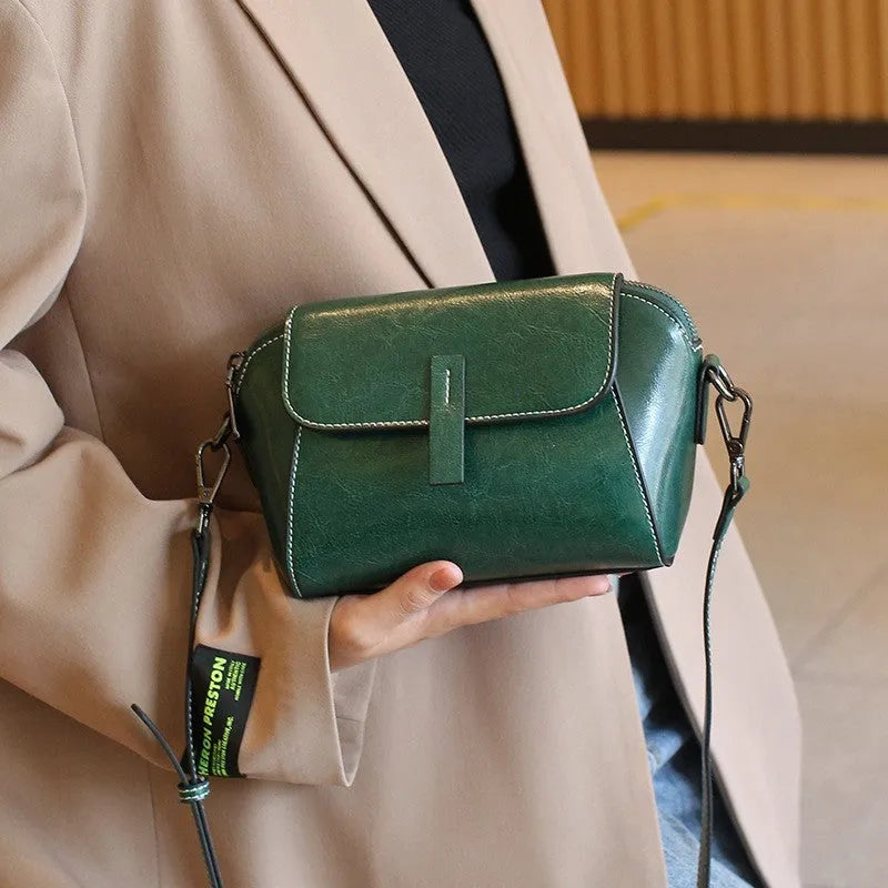 Women's brown oil wax leather messenger bag with cross-body strap and multiple internal compartments