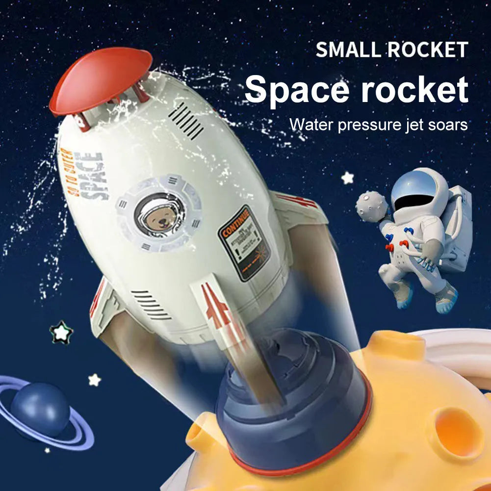 Water pressure rocket launcher toy on green grass with water spray, yellow rocket, and base connector