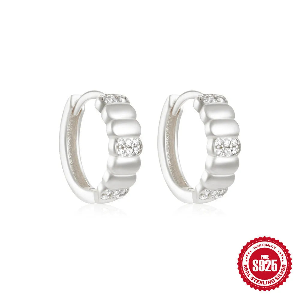 Small round geometric sterling silver stud earrings in gold and silver electroplated finishes.