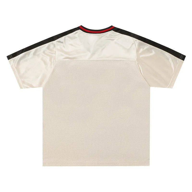 Apricot coloured V-neck sports top with drop-shoulder sleeves and letter pattern detail