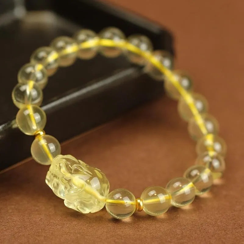Yellow artificial crystal Pi Xiu bracelet on a leather cord in Chinese national style.