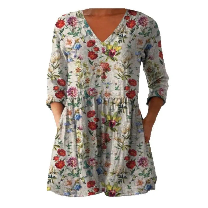 A woman wearing a loose-fitting printed dress with 3/4 sleeves and a wide waist.