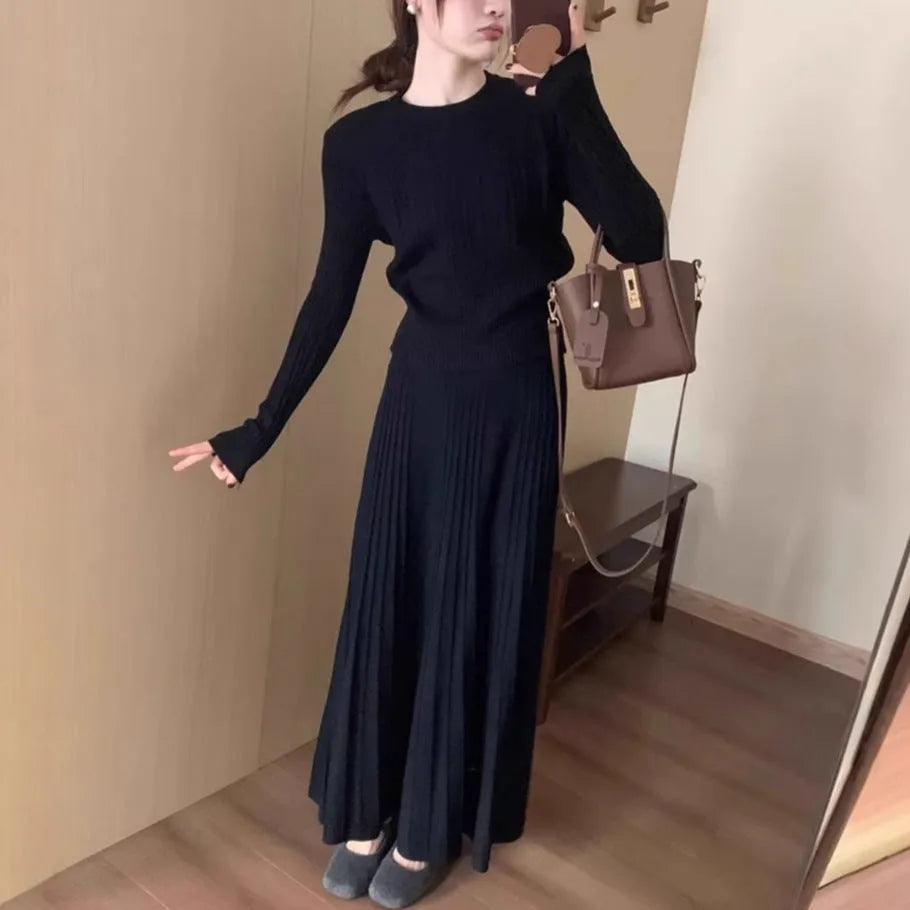 Women's dark grey knitted sweater and skirt suit set with textured 3D pattern and collage stitching.