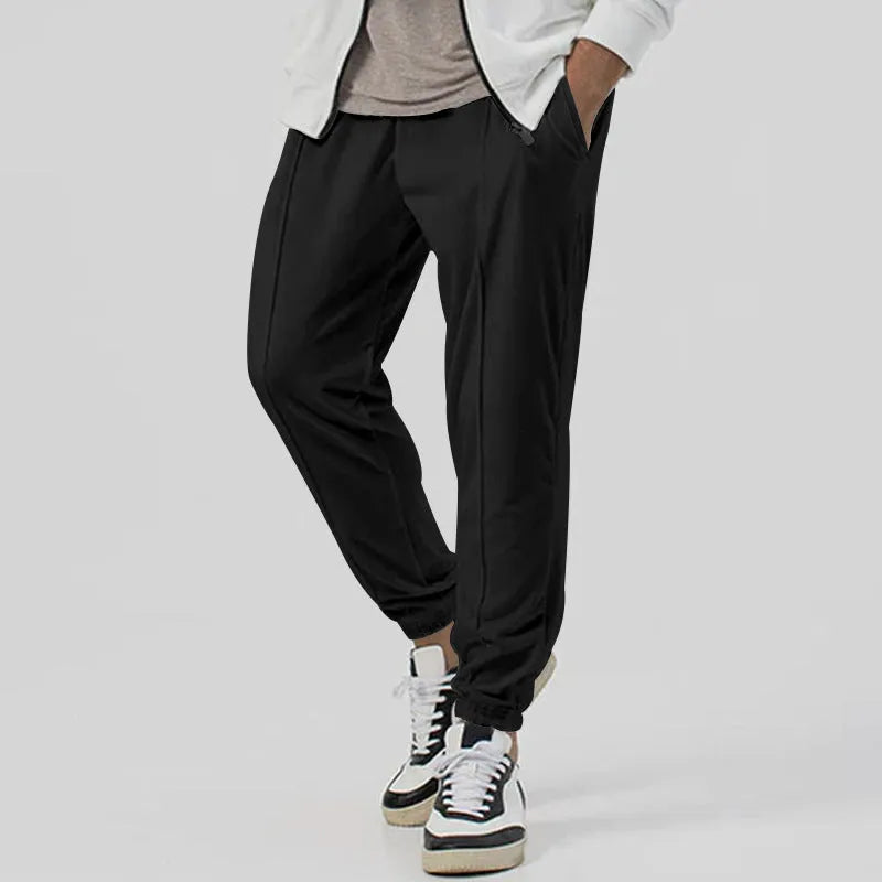 Men's loose tapered casual track sweatpants in cotton blend fabric showing straight-leg design