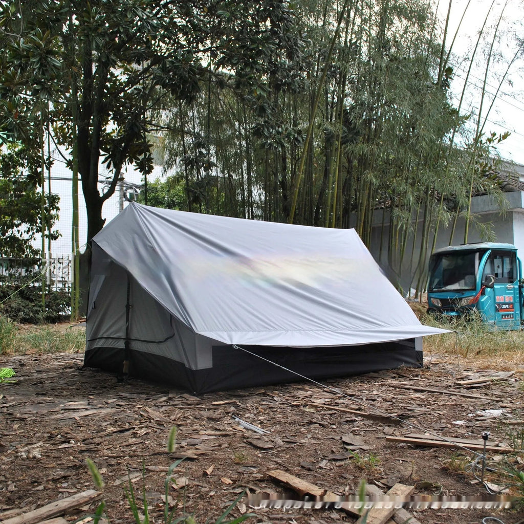 Brown or white A-line hiking tent pitched using hiking canes, showing spacious interior for 2-3 people.