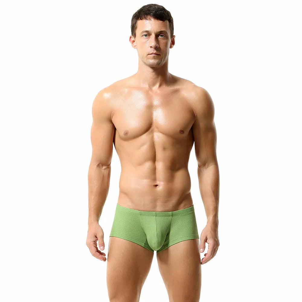 Men's solid colour low-waist nylon boxer shorts on a white background.