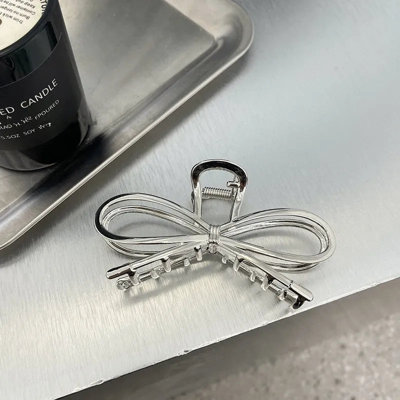 Women's bow barrette hair grip in gold or silver with Korean style design
